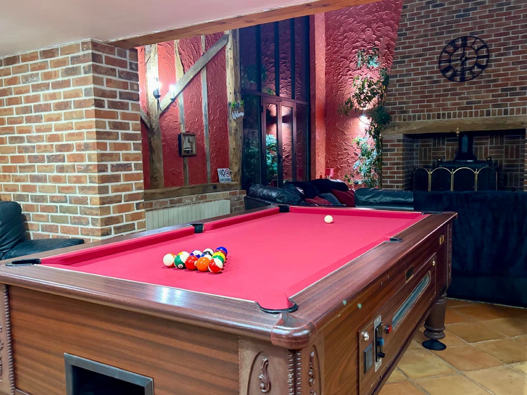 Games room with pool table beside the fireplace