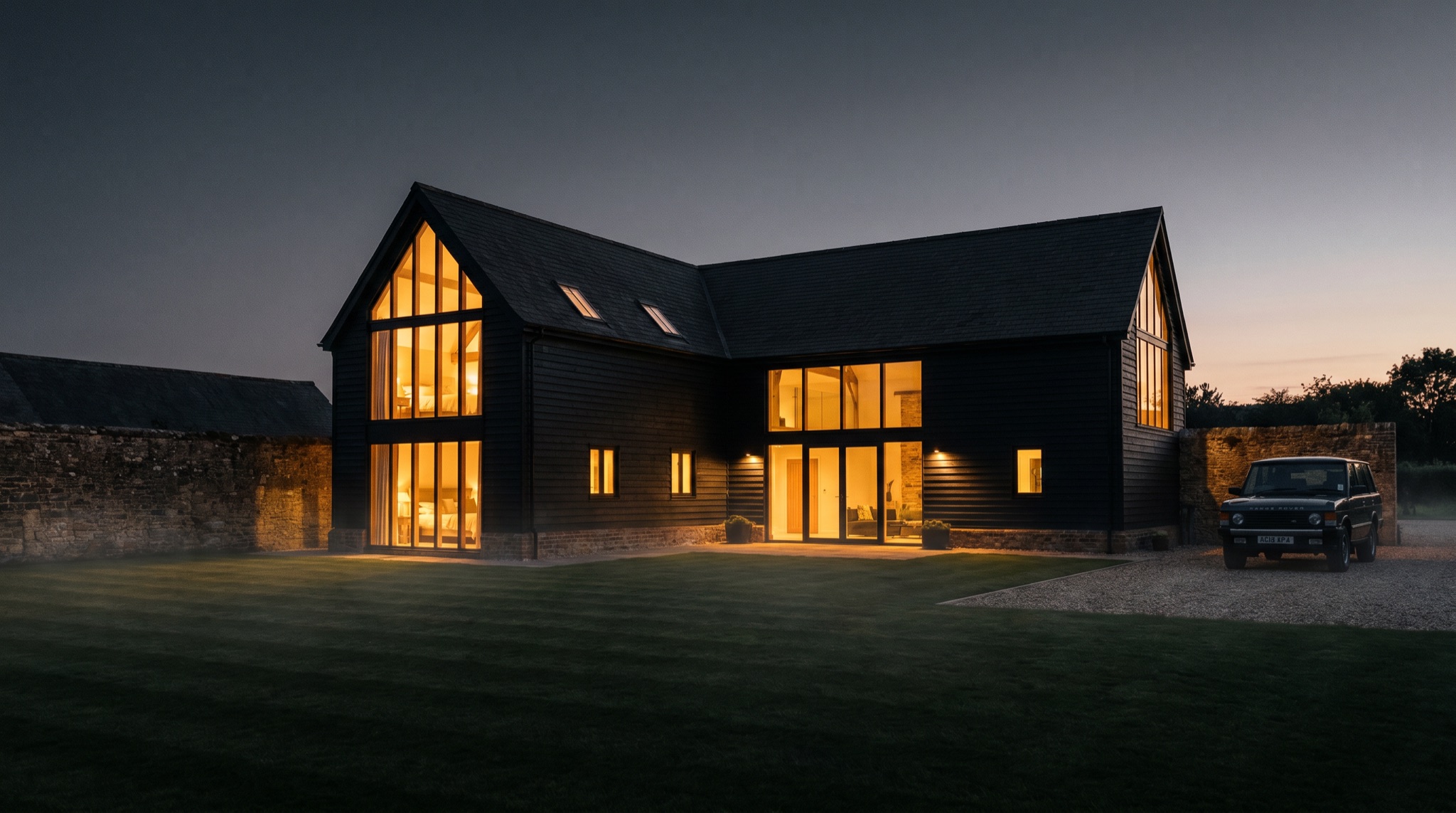 Clamp Farm Barn glowing at dusk